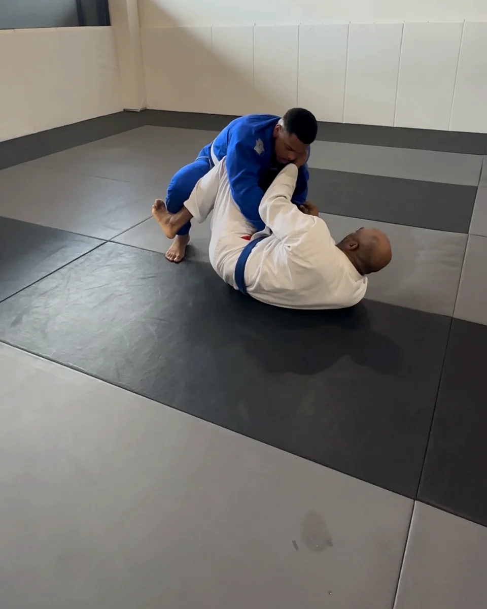 Training partners working grips in the gi