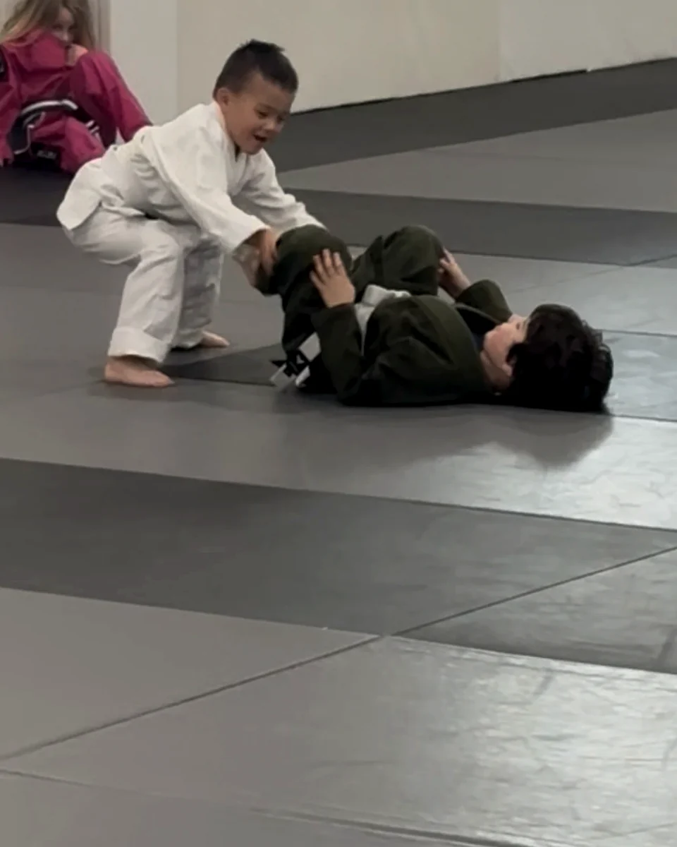 Young kids learning basics on the mat