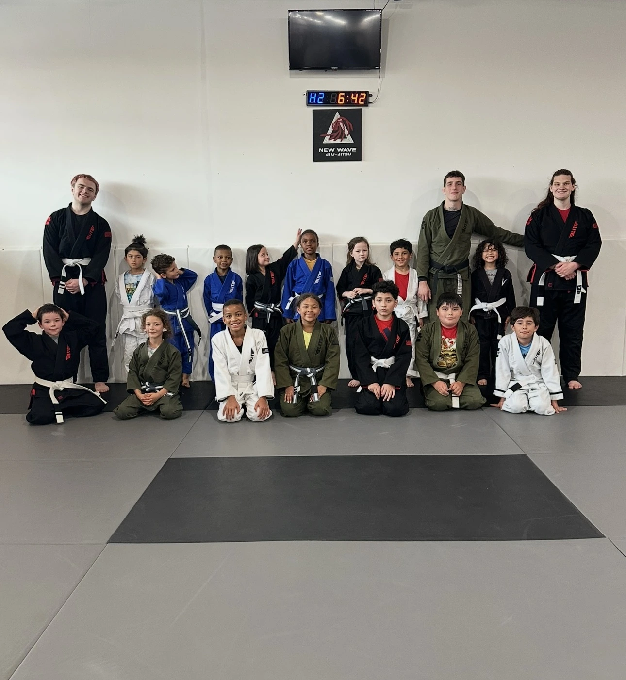 The kids and youth class together on the mats at New Wave Jiu Jitsu