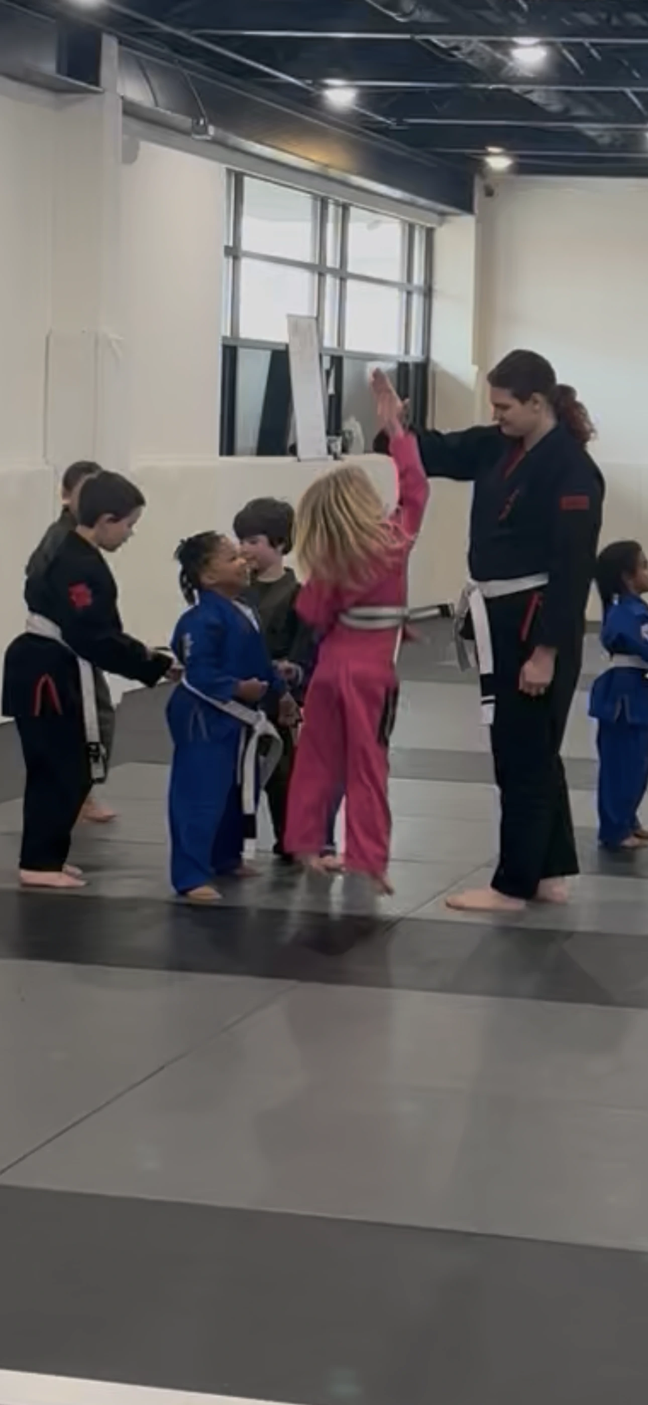 A coach high-fiving a young student