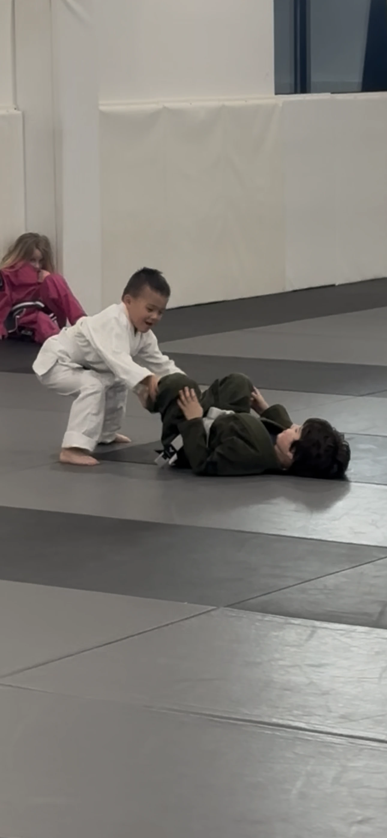 Young children learning the basics of Jiu-Jitsu in a structured class